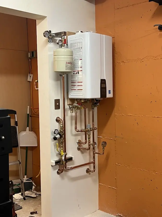 Plumbing technician inspecting water heater connections in Menlo Park